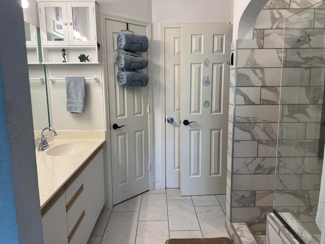 bathroom with vanity and a shower