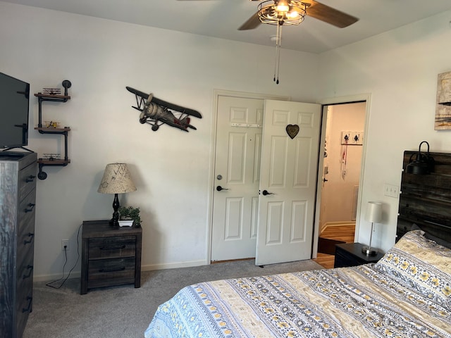 carpeted bedroom featuring ceiling fan and a closet