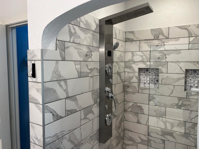 bathroom with tiled shower