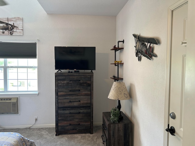 carpeted bedroom with a wall unit AC