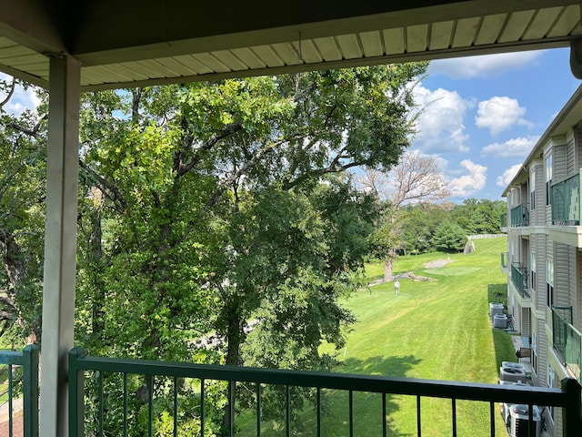 view of yard featuring a balcony and central air condition unit