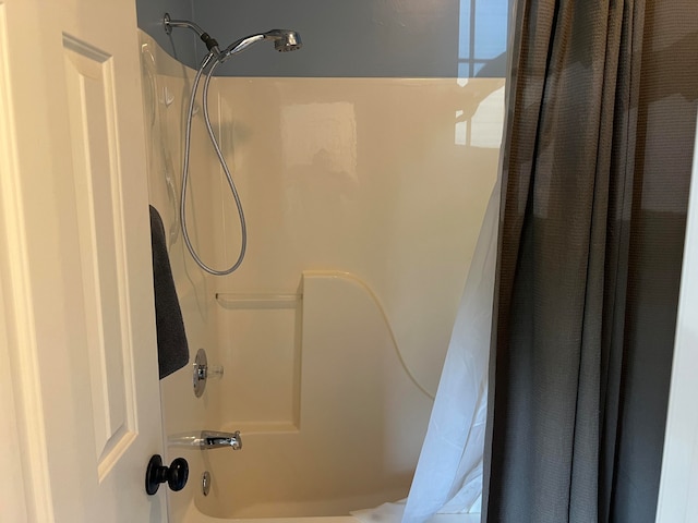 bathroom with shower / bathtub combination with curtain