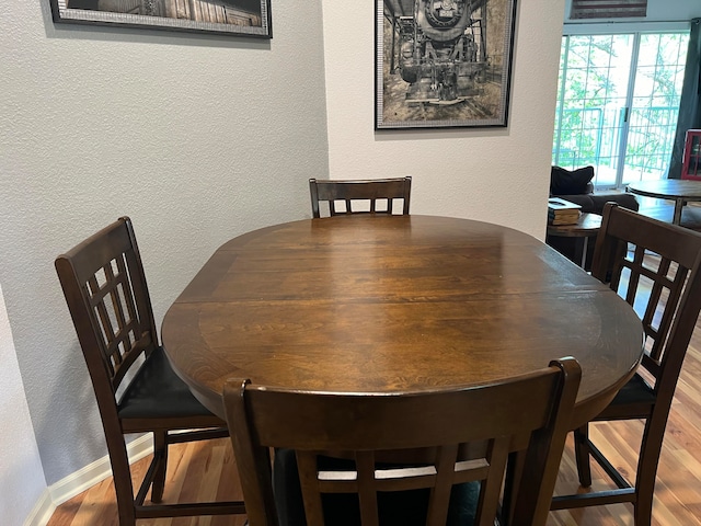 dining area with hardwood / wood-style floors