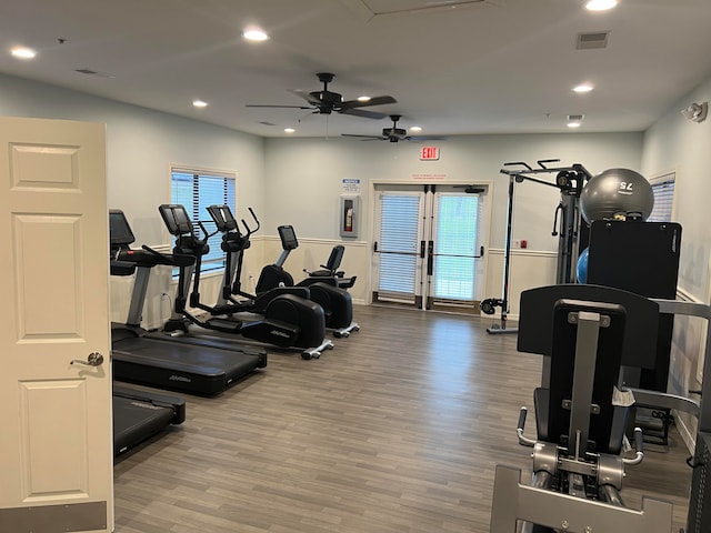 workout area featuring ceiling fan, light hardwood / wood-style flooring, and a wealth of natural light