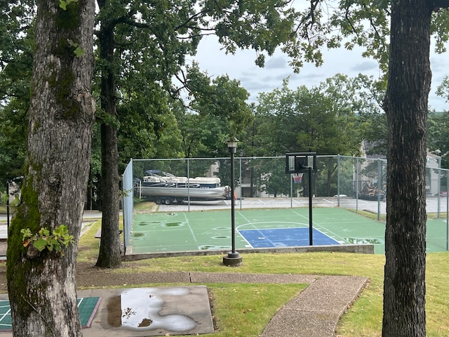 view of sport court featuring a yard