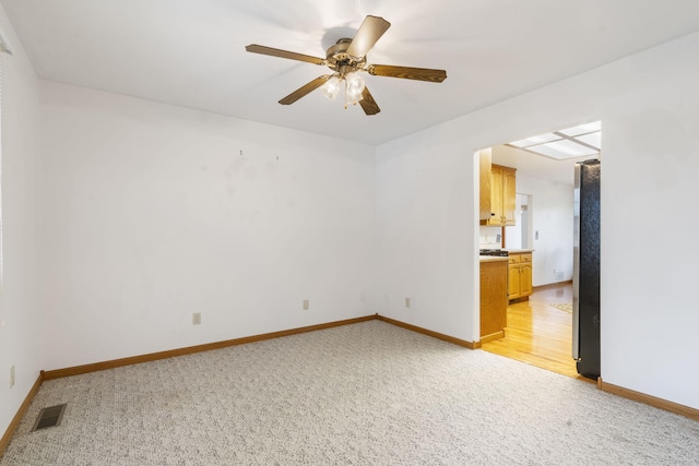 spare room with light hardwood / wood-style floors and ceiling fan