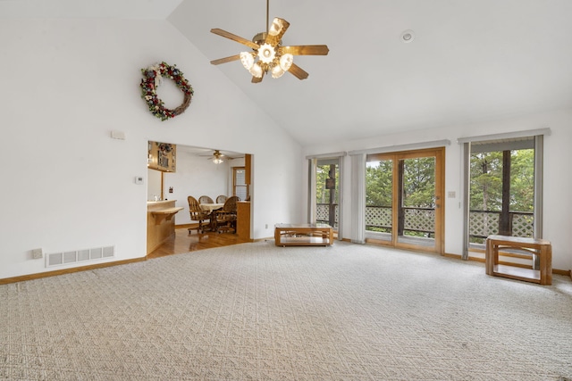 unfurnished living room with plenty of natural light, high vaulted ceiling, and ceiling fan