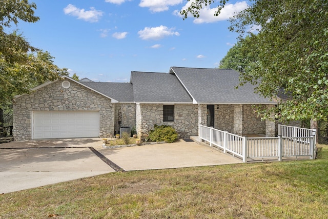 ranch-style house with a garage and a front lawn