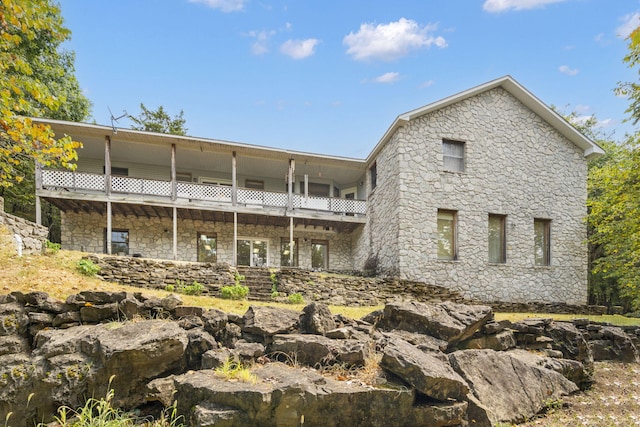 back of property featuring a balcony