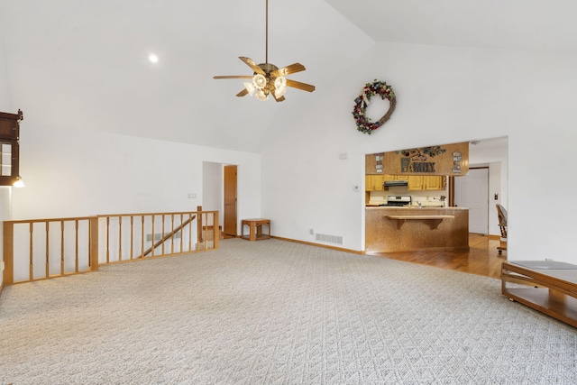 living room featuring ceiling fan, carpet, and high vaulted ceiling