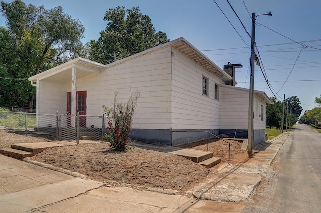 view of side of home with fence