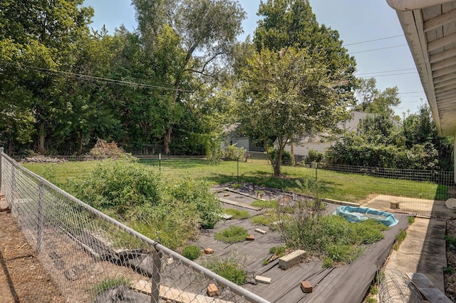 view of yard featuring fence and a garden