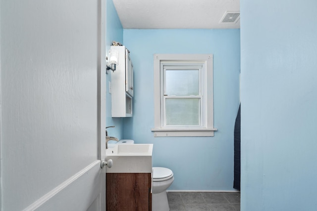 half bathroom with visible vents, toilet, and vanity
