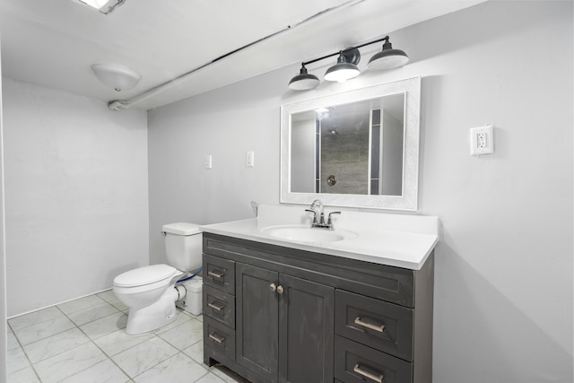 bathroom featuring walk in shower, vanity, and toilet