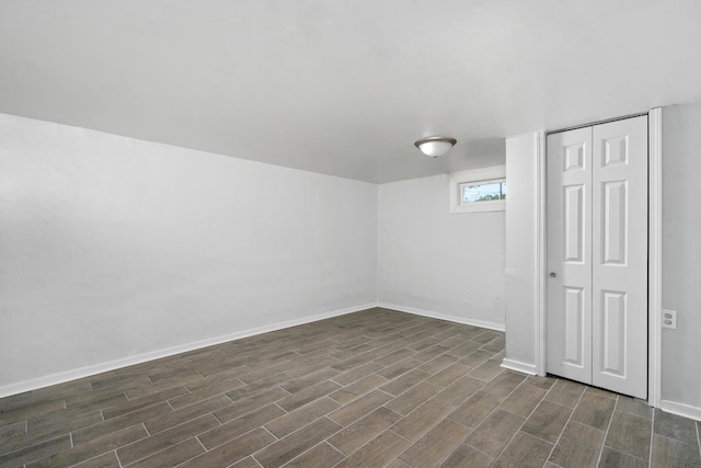 basement with dark hardwood / wood-style flooring