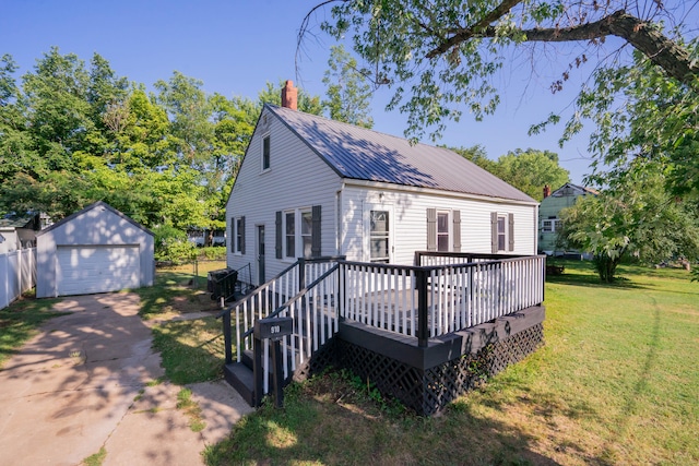 view of front facade featuring a garage, a front yard, an outbuilding, and a deck