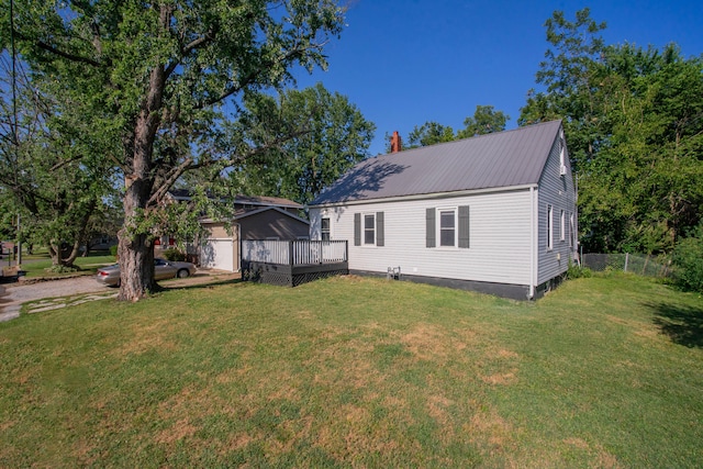 rear view of property featuring a yard and a wooden deck