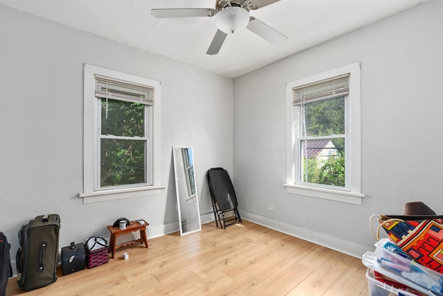 sitting room with light wood-type flooring and ceiling fan