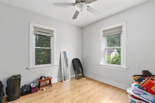 miscellaneous room with wood finished floors, a ceiling fan, and baseboards