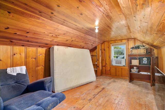 additional living space featuring lofted ceiling, wooden walls, wood-type flooring, wood ceiling, and cooling unit
