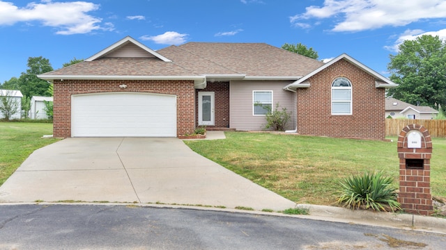 ranch-style home featuring a front lawn and a garage