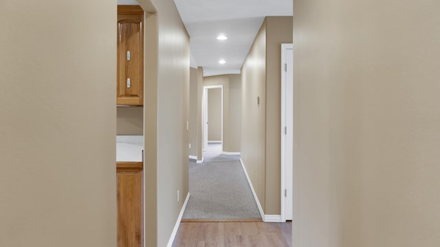 corridor with light hardwood / wood-style flooring