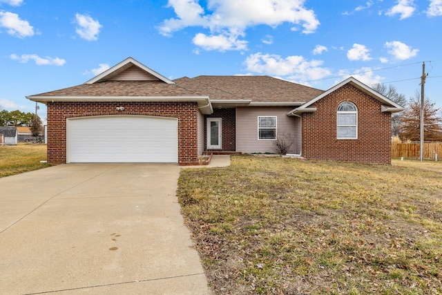 ranch-style house featuring a garage and a front lawn