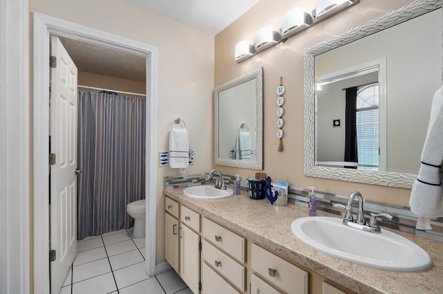 bathroom featuring a textured ceiling, tile patterned floors, vanity, and toilet