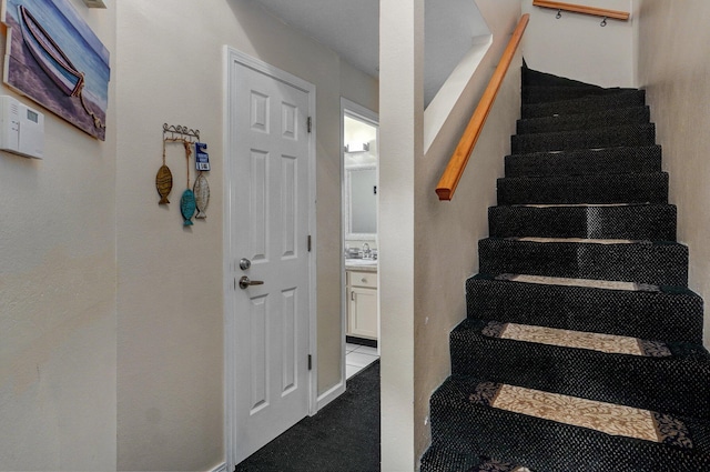 staircase featuring sink