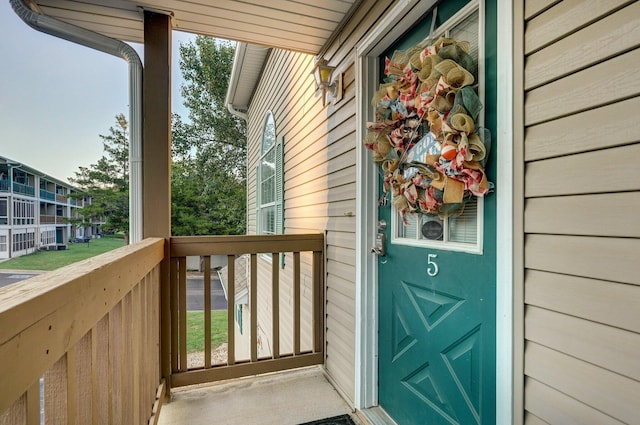 view of exterior entry with a balcony