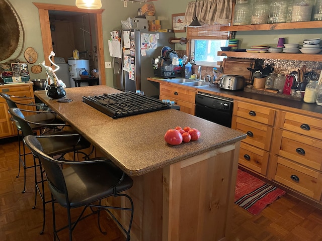 kitchen with sink, dishwasher, dark parquet flooring, stainless steel refrigerator with ice dispenser, and a breakfast bar area