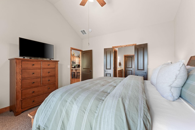 carpeted bedroom featuring ensuite bathroom, high vaulted ceiling, and ceiling fan