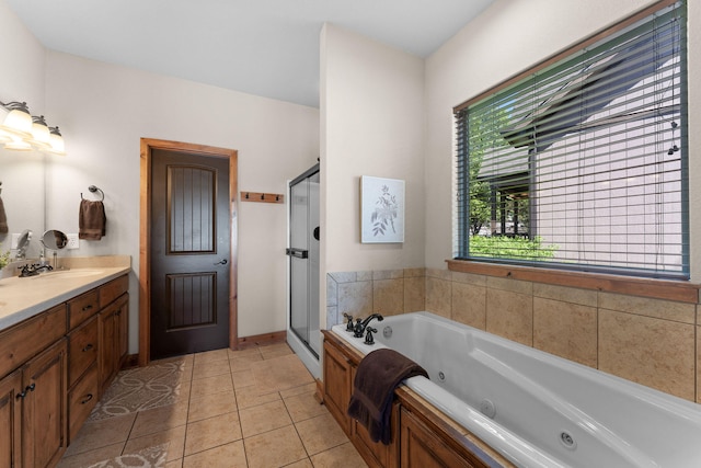 bathroom with tile patterned floors, vanity, and independent shower and bath