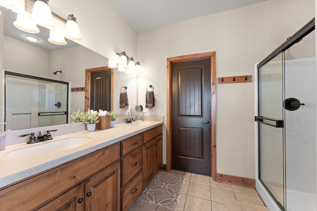 bathroom featuring tile patterned floors, vanity, and an enclosed shower