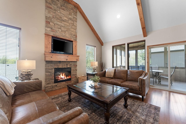 living room featuring beamed ceiling, high vaulted ceiling, a fireplace, and wood-type flooring