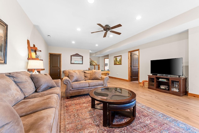 living room with light wood-type flooring and ceiling fan