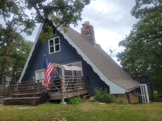 back of house with a yard and a wooden deck