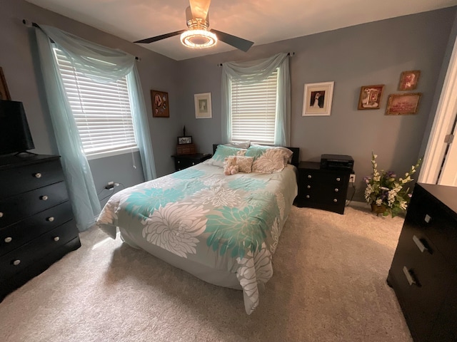 bedroom featuring ceiling fan and light carpet