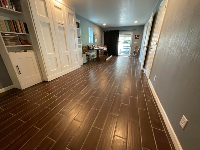 corridor featuring dark wood-type flooring