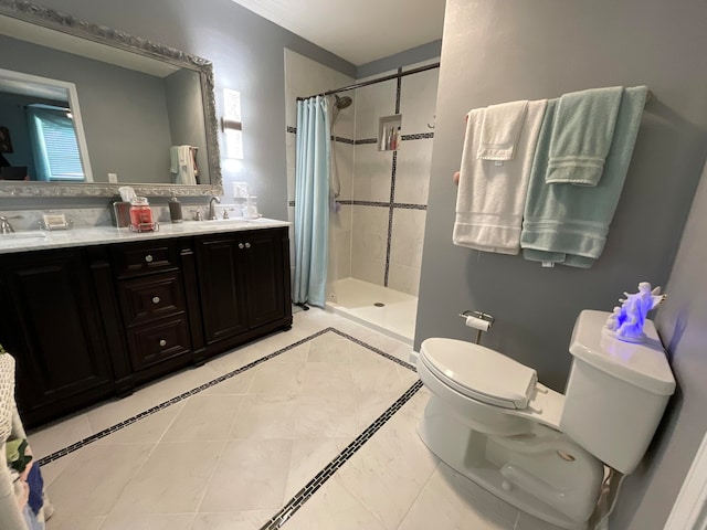 bathroom with tile patterned floors, vanity, curtained shower, and toilet