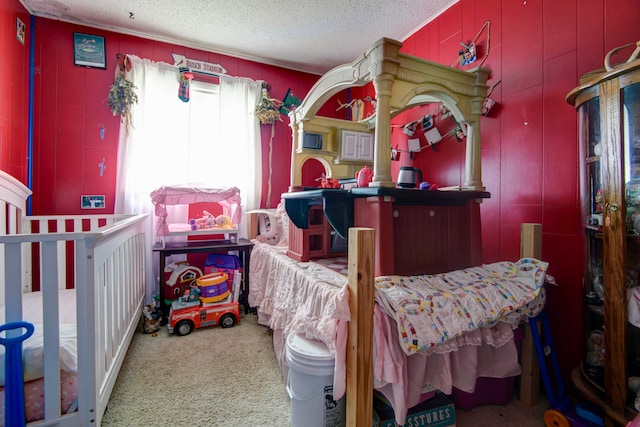 carpeted bedroom with a textured ceiling