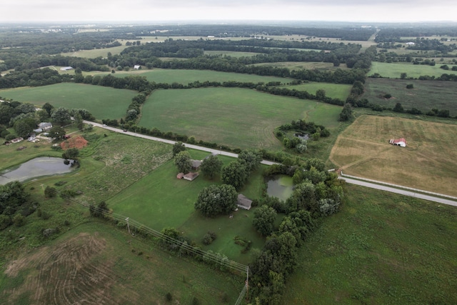 birds eye view of property featuring a water view and a rural view