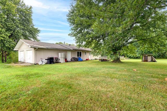 view of yard featuring a garage and a shed