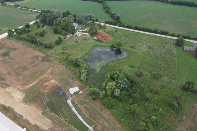 birds eye view of property with a water view and a rural view