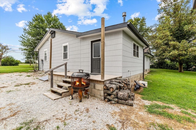 rear view of property with a lawn