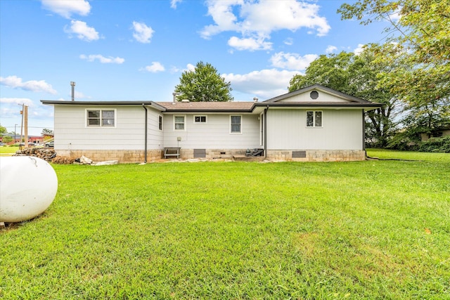 rear view of property with a yard and central AC