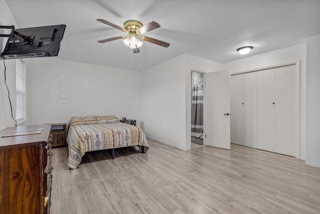 bedroom featuring a closet, light hardwood / wood-style flooring, and ceiling fan