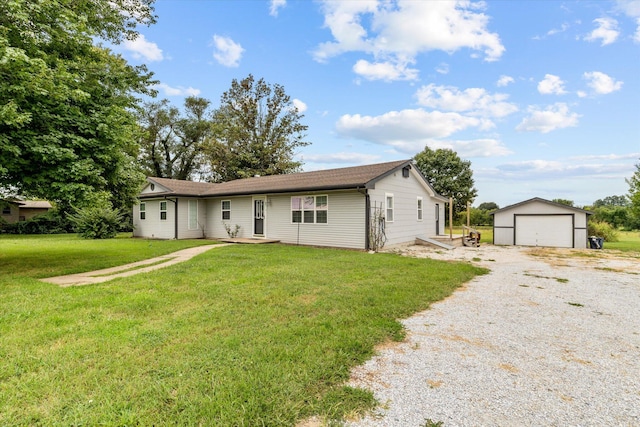 ranch-style house with a garage, a front yard, and an outbuilding