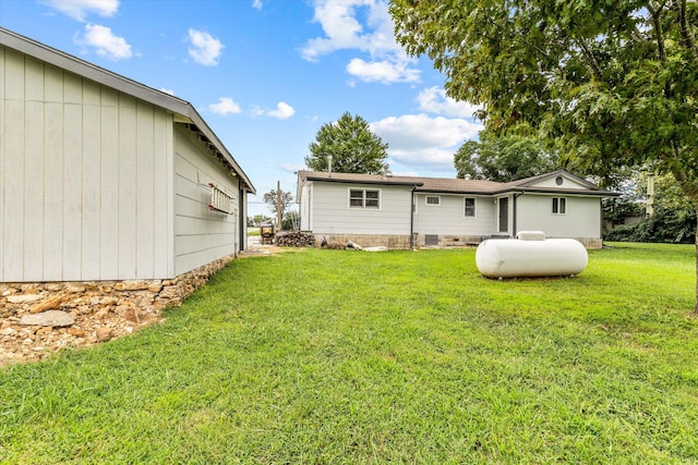 rear view of property featuring a lawn