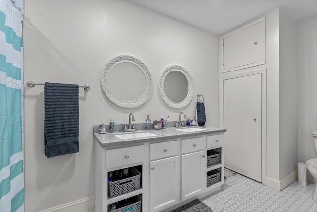 bathroom featuring vanity, toilet, and tile patterned floors